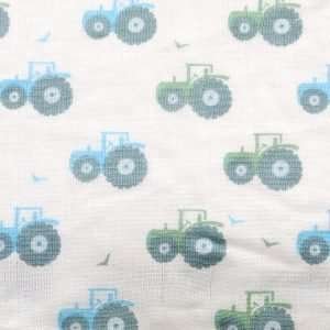 A box set of three muslins in blue colours. One has blue and grey stripes, one with blue tractors and another with blue and grey dinosaurs