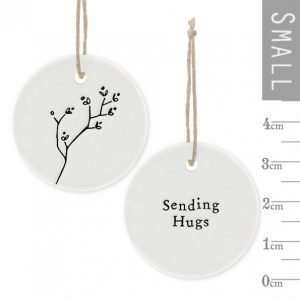 A sweet Sending Hugs Floral Hanger from the ceramic range by East of India. A small keepsake with brown string hanger.