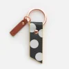 Charcoal spot tab key ring from Caroline Gardner. A black tab of faux leather with white spots on a rose gold key ring