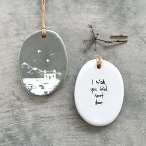 A lovely keepsake hanger with a mountain scene on one side and the words I wish you lived next door on the other side.