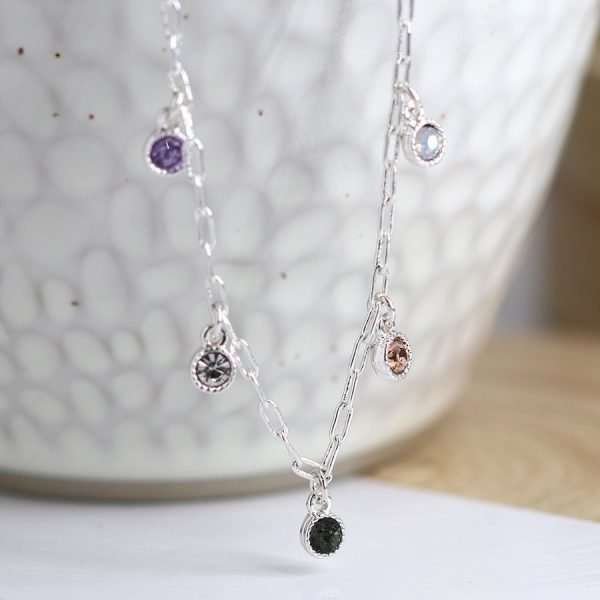Mixed Crystal Necklace. Silver plated fine chain necklace with tiny mixed colour faceted crystals in fluted round silver plated settings. This necklace is fastened with a lobster clasp and has an extension chain to adjust the length.