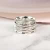 Hand crafted spinning ring made from fine quality beaten sterling silver with three moving bands
