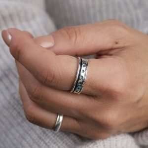 Sterling silver hand crafted spinning ring with a moving multi star band and oxidised detailing