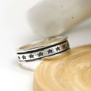 Sterling silver hand crafted spinning ring with a moving multi star band and oxidised detailing
