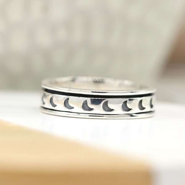 Sterling silver hand crafted spinning ring with a moving multi moon band and oxidised detailing