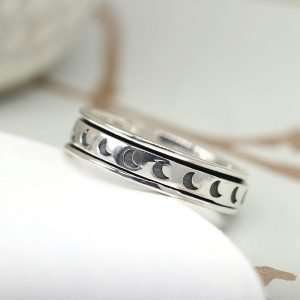 Sterling silver hand crafted spinning ring with a moving multi moon band and oxidised detailing