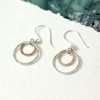 Silver And Rose Gold Double Hoop Earrings. Sterling silver double hoop earrings with larger silver hoops and smaller rose gold hoops in a hammered finish