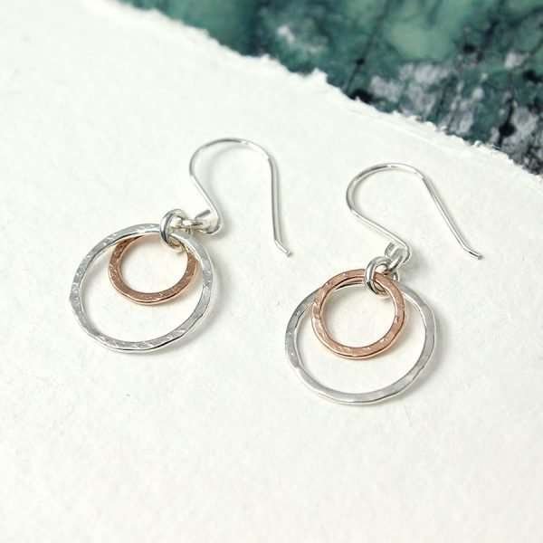 Silver And Rose Gold Double Hoop Earrings. Sterling silver double hoop earrings with larger silver hoops and smaller rose gold hoops in a hammered finish
