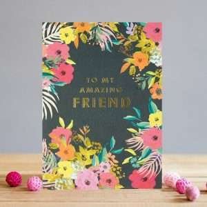 A card with really bright flowers on a dark background and to an amazing friend in gold