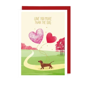 This card features a sausage dog walking through a park and reads 'Love you more than the dog'.
