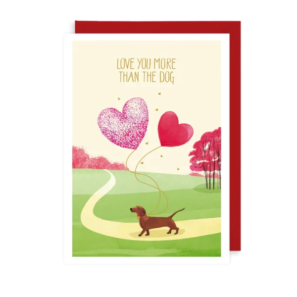 This card features a sausage dog walking through a park and reads 'Love you more than the dog'.