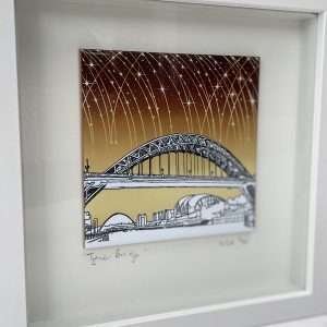 A fantastic Colourful Tyne Bridge tile picture with a pen and ink design and yellow and brown background, set in a box frame.