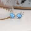 sterling silver teardrop stud earrings set with a striking blue opal
