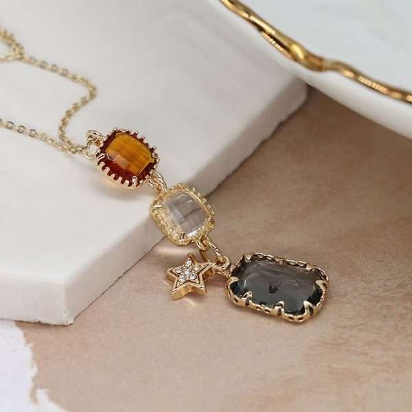 Fine golden chain necklace with smoky grey, bronze and clear square glass crystals in faux gold claw settings. Each crystal is linked together and a little faux gold plated crystal inset star charm