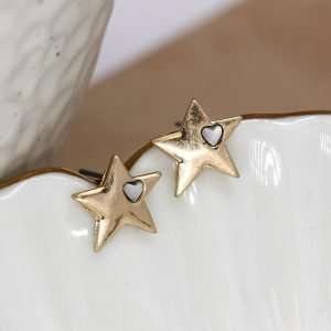 Star shaped stud earrings with faux gold plating in a worn finish and an off-centre single heart shaped white quartz set into each heart