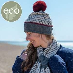 A popcorn knit bobble hat and pull through short scarf set. The hat and scarf have matching fluffy pom pom and trim in burgundy