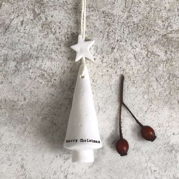 A white porcelain christmas tree with a star on top and merry christmas printed in black around the bottom. A hanging Christmas tree decoration