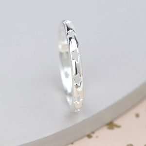 Sterling silver ring with smooth rounded surface and star cut-out pattern around the band