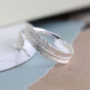 Sterling silver wrap around ring with an intricately crafted feather design