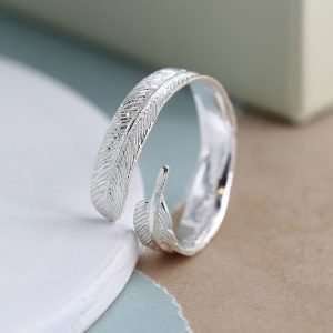 Sterling silver wrap around ring with an intricately crafted feather design