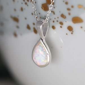 Sterling silver teardrop shape pendant with a synthetic white opal inset and fine silver chain