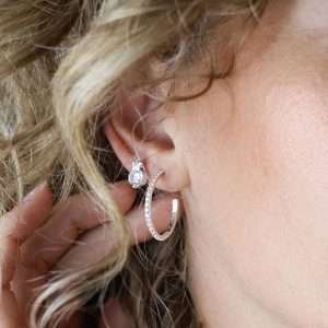 Sterling silver star shaped stud earrings with a round faceted clear CZ crystal beneath each star