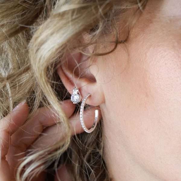 Sterling silver star shaped stud earrings with a round faceted clear CZ crystal beneath each star
