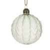 A clear glass bauble with overlapping leaf pattern