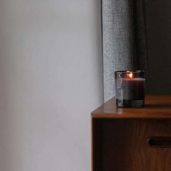 A gorgeous Patchouli and Black pepper candle in a smokey glass jar from Cumbrian based Bath House