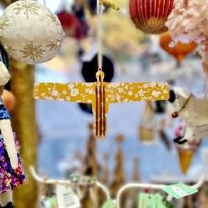 A hanging Angel of the North decoration in Liberty print Summer Bloom