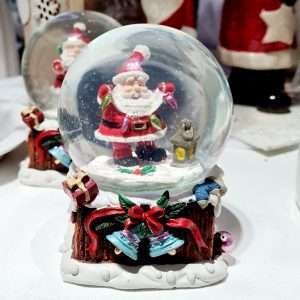 A snow globe with a jolly santa