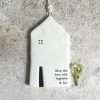 A lovely porcelain hanging decoration in the shape of a house with the words Bless this house with happiness and love imprinted on it