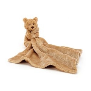 A brown softly textured toy bear is hugging an un-stuffed square shaped soother blanket