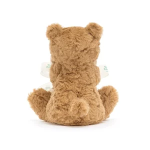 A brown softly textured toy bear is hugging an un-stuffed square shaped soother blanket