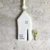 A white porcelain house shaped hanging decoration with the words Love Hope Dream imprinted on it.