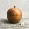 A lovely apple ornament carved out of wood.