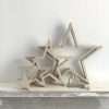 A set of four hanging natural outline hanging wooden stars in 4 different sizes