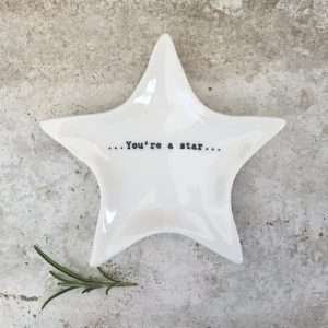 A star shaped white porcelain trinket dish with you're a star written on the bottom