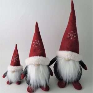 A fabric gonk with a grey coat, red hat, red boots in 2 sizes