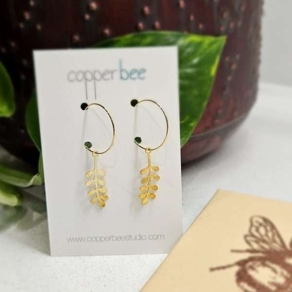 Brass sprig motifs hung on gold plated hoops