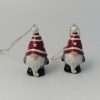 A ceramic santa gonk hanging decorationwith a red hat grey coat white beard black boots