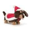A toy sausage dog from jellycat with a red santa hat and coat