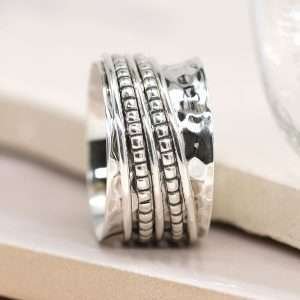 Sterling silver hammered wide band spinning ring with decorative silver dotted moving bands