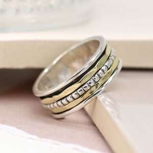 Sterling silver spinning ring with simple double brass and silver dotted silver bands