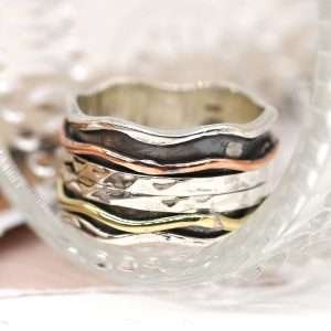 Sterling silver wave edge spinning ring with hammered moving silver bands and copper & brass wave band