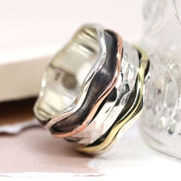 Sterling silver wave edge spinning ring with hammered moving silver bands and copper & brass wave band