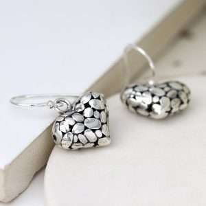 Sterling silver rounded pebble heart drop earrings with a smooth polished surface on fine silver earring hooks.