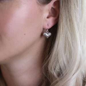 Sterling silver rounded pebble heart drop earrings with a smooth polished surface on fine silver earring hooks.