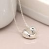 Silver plated fine chain necklace with a heart pendant featuring a gentle wave surface and polished finish