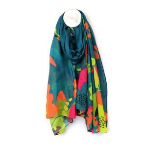 Teal blue scarf made from Repreve, a yarn created from recycled plastic bottles, featuring a vibrant tropical paradise print edge